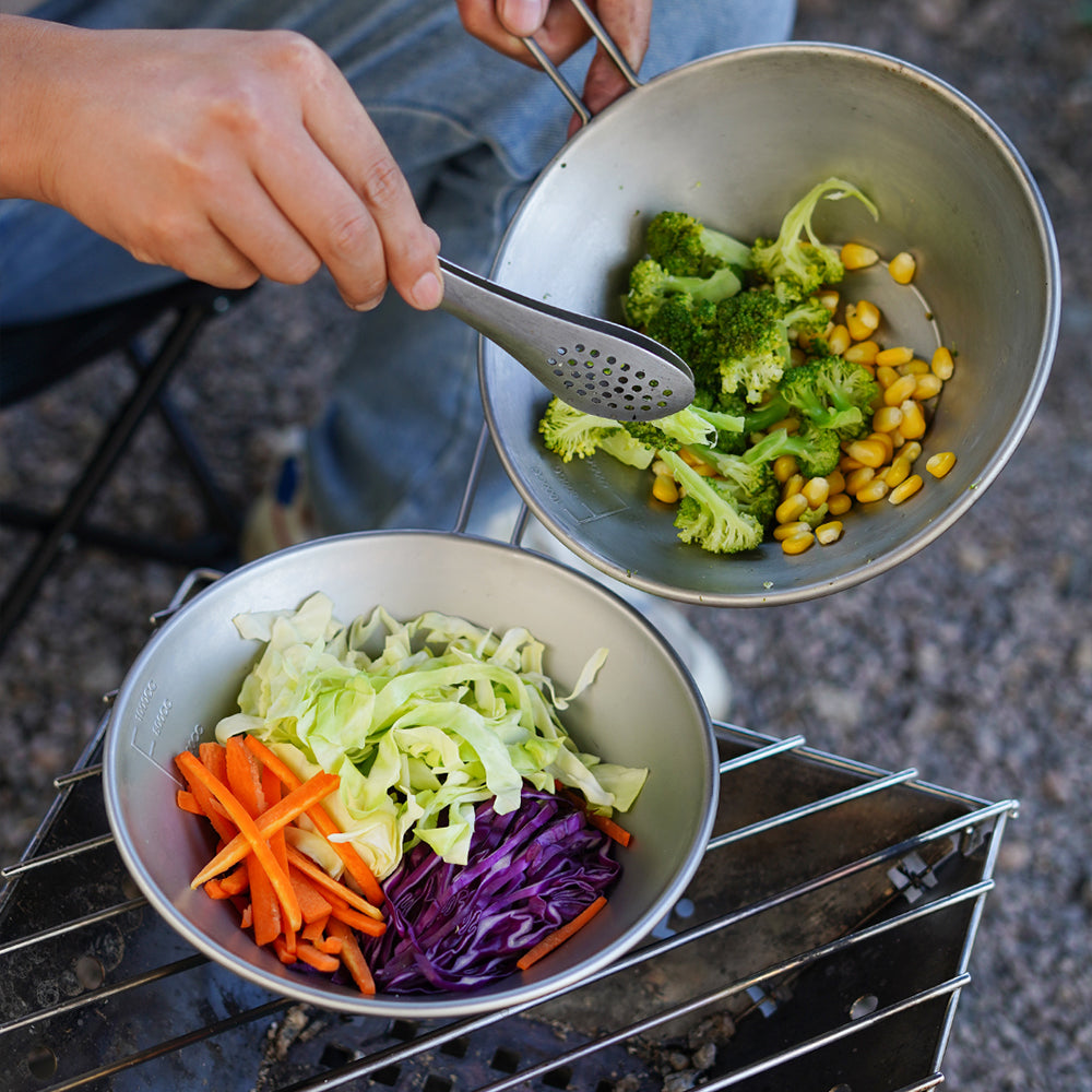 Hands cooking vegetables in Winnerwell stainless steel Sierra camping cookware set
