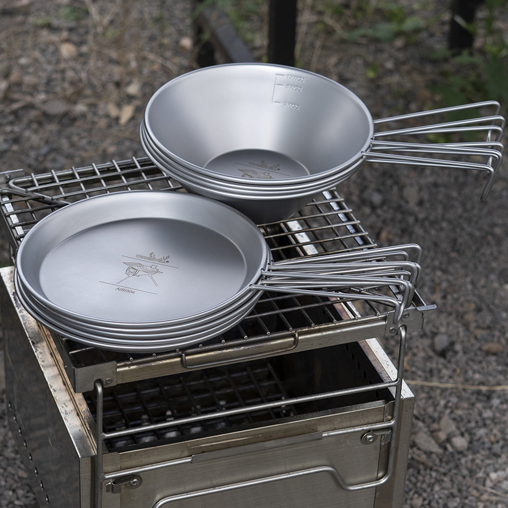 Winnerwell stainless steel Sierra camping cookware bowl and plate set on an outdoor grill
