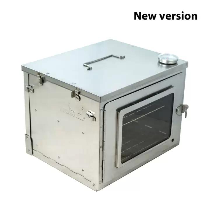 Outdoor baking oven in use at campsite cooking food on wood burning stove