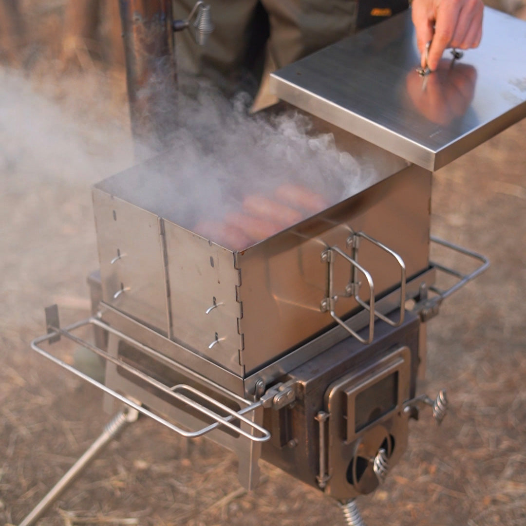 Winnerwell Flat Smoker in use at campsite — portable camping smoker over stove cooking outdoors